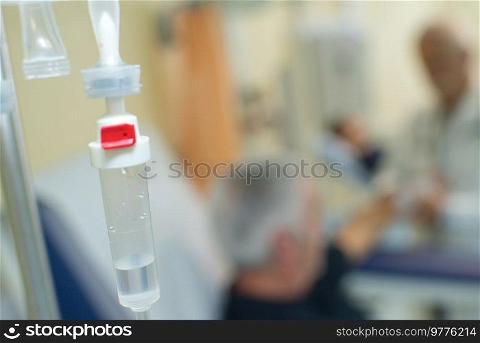 saline solutions bottle hanging and dripping in hospital