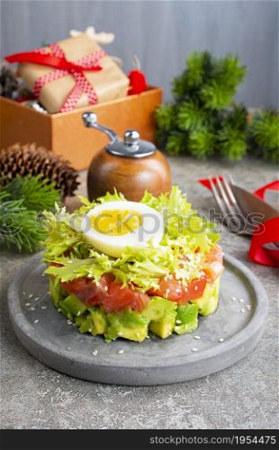 salmon and avocado and cucumber. salad on plate