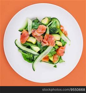 Salmon avocado salad with salted fish, lettuce, broccoli and cucumbers