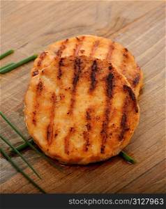 Salmon Burgers On A Wooden Board