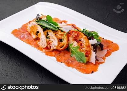 salmon carpaccio served with toast on plate