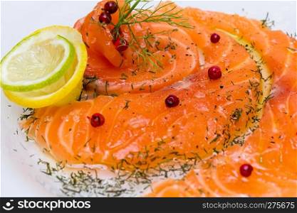 Salmon carpaccio with pink pepper, dill and juice of lemons