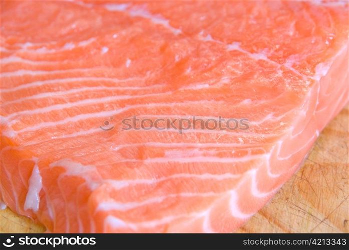salmon closeup slice at wooden board