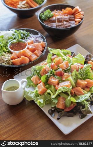 salmon fish fillet served with fresh vegetables on dish, set of japanese style seafood dishes. salmon fish fillet served with fresh vegetables