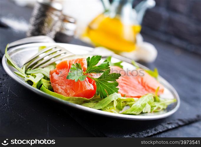 salmon fish with fresh salad on plate