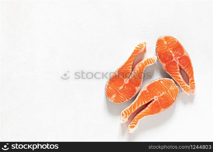 Salmon. Fresh raw salmon fish steaks on white background, top view