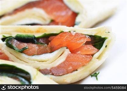 salmon in puff pastry on white dish