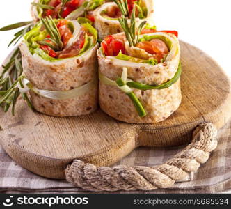 Salmon lavash rolls with fresh salad leafs