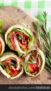 Salmon lavash rolls with fresh salad leafs