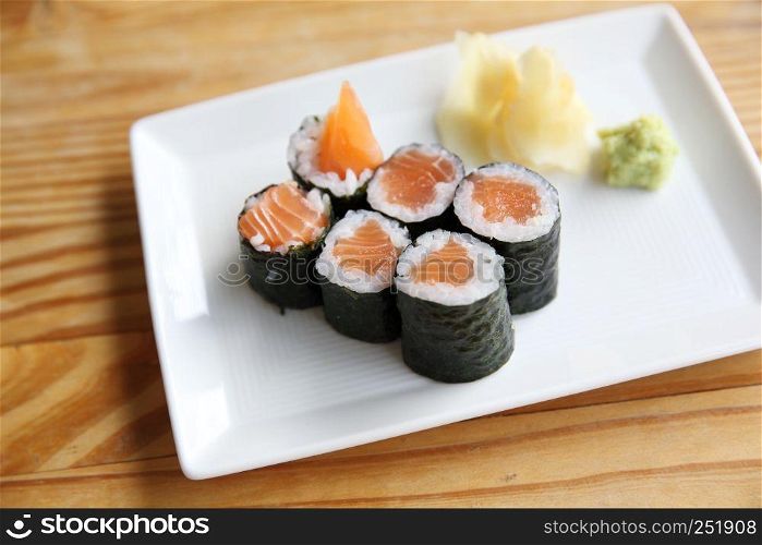 Salmon Maki sushi on wood background