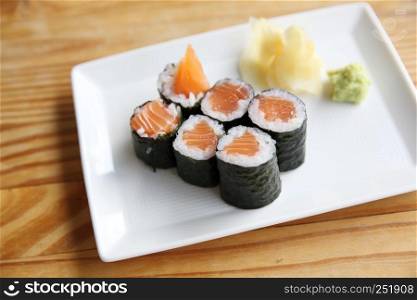 Salmon Maki sushi on wood background