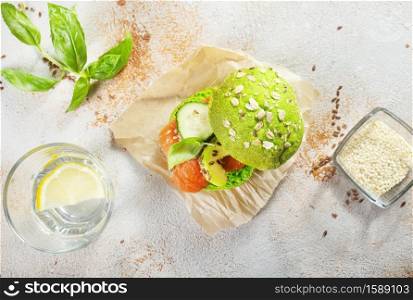 Salmon on bread slices, burger with avocado and salmon