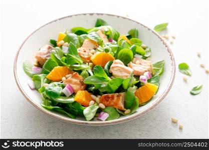Salmon orange salad with pine nuts, red onion and corn salad. Breakfast. Ketogenic diet