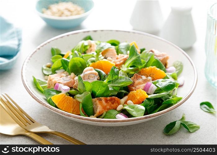 Salmon orange salad with pine nuts, red onion and corn salad. Breakfast. Ketogenic diet
