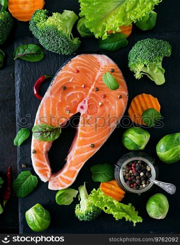 Salmon roasted in an oven with a butter, parsley and garlic. Portion of cooked fish and fresh lemon on a white plate