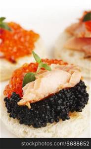 Salmon roe, sea weed roe, smoked salmon and onion on the toasts