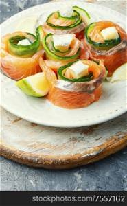 Salmon roll with cheese,cucumber and lime.Rolls of red fish fillet. Trout or salmon roll
