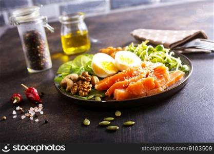 salmon salad with greens, eggs and nuts. Keto bowl salmon salad with greens, eggs and nuts