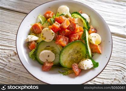 Salmon salad with mozzarella tomato cucumber on bowl
