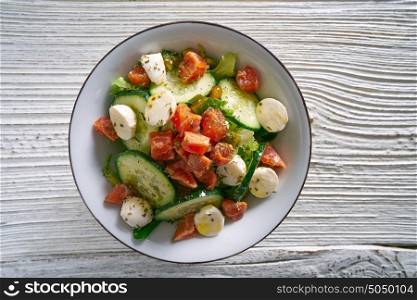 Salmon salad with mozzarella tomato cucumber on bowl