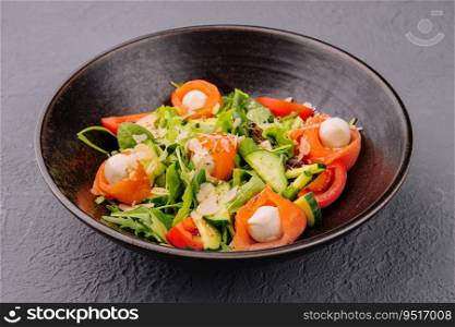 Salmon salad with mozzarella tomato cucumber on bowl. Salmon salad with mozzarella, tomato, cucumber on bowl