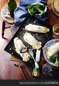 Salmon spinach filo pies, broccolini and wine