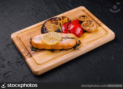 Salmon steak on the grill with grilled vegetables