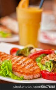salmon steak. Tasty dish of salmon steak with vegetables and juice