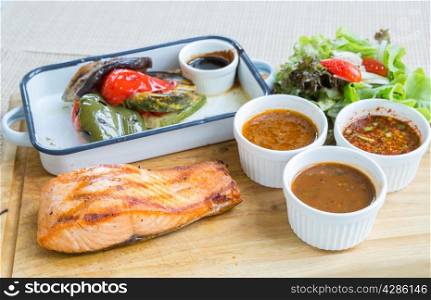 salmon steak with grilled vegetable and assorted sauce