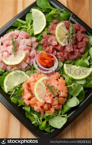 salmon, tuna and swordfish tartare with fresh salad