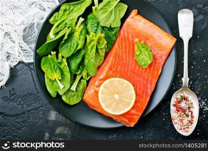 salmon with lemon and fresh spinach, diet food