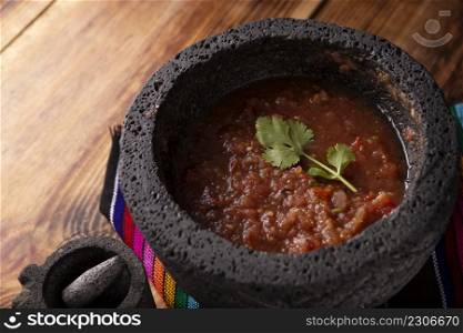 Salsa Roja de Molcajete. Traditional mexican version of mortar and pestle handmade of volcanic stone. Essential element in the preparation of the authentic Mexican sauce