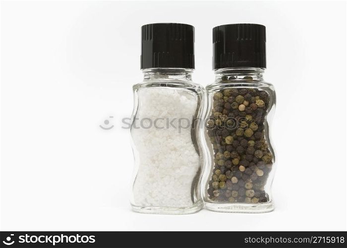 Salt and pepper grinders standing on a white background
