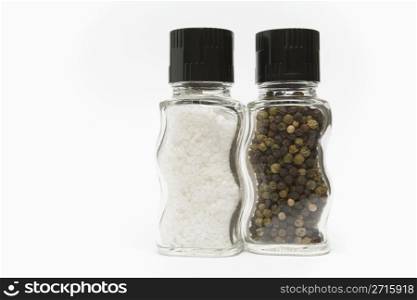 Salt and pepper grinders standing on a white background