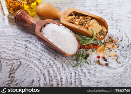 Salt and spices in white wooden background