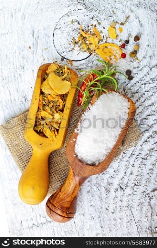 Salt and spices in white wooden background