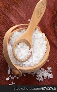 salt crystals in wooden bowl with spoon