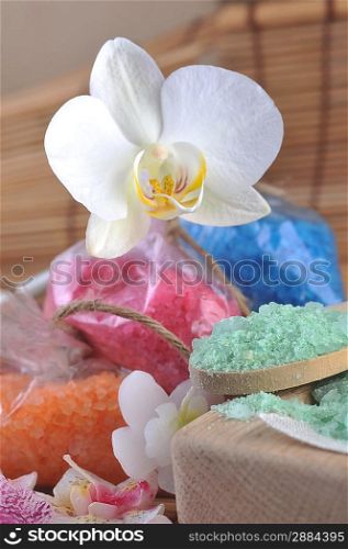 salt for bath, flower, candles on straw napkin