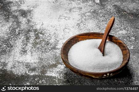 Salt in a bowl. On rustic background.. Salt in a bowl.