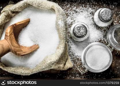 Salt in an old bag on a tray. On rustic background.. Salt in an old bag on a tray.