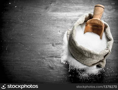 Salt in an old bag. On the black chalkboard.. Salt in an old bag.