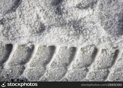 salt texture with truck footprint road ice background