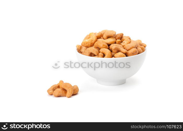 salted cashew nuts in white ceramic bowl isolated on white background with clipping path