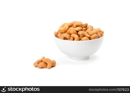 salted cashew nuts in white ceramic bowl isolated on white background with clipping path