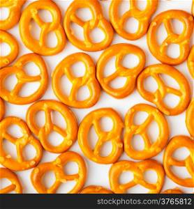 Salted fresh pretzels pattern as food background on white