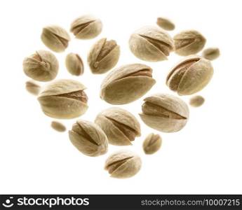 Salted pistachios in the shape of a heart on a white background.. Salted pistachios in the shape of a heart on a white background
