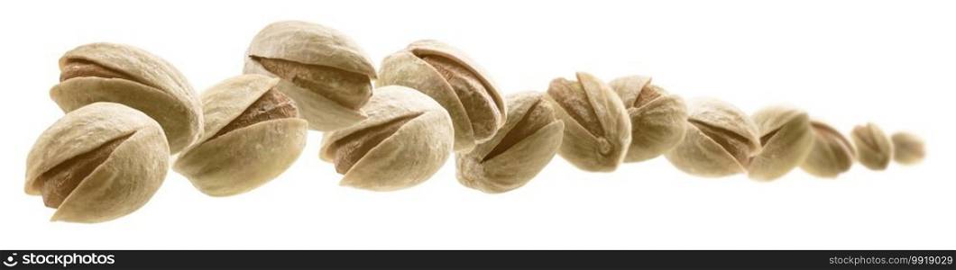 Salted pistachios levitate on a white background.. Salted pistachios levitate on a white background