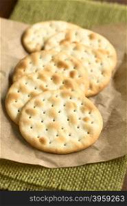 Saltine or soda crackers, photographed with natural ight (Selective Focus, Focus in the middle of the first cracker)