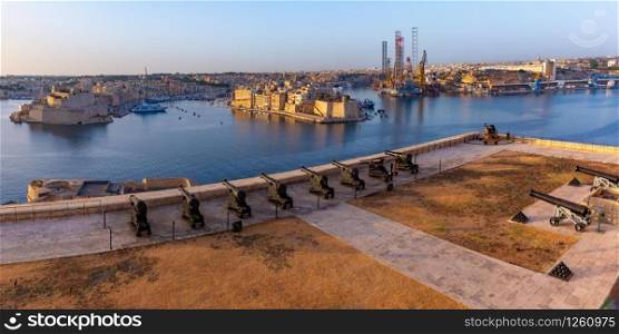 Saluting Battery at Fort Lascaris as seen from Upper Barrakka Gardens, with Grand Harbor, Senglea and Brigu on the background, Valletta, Malta.. Upper Barrakka Gardens in Valletta, Malta.