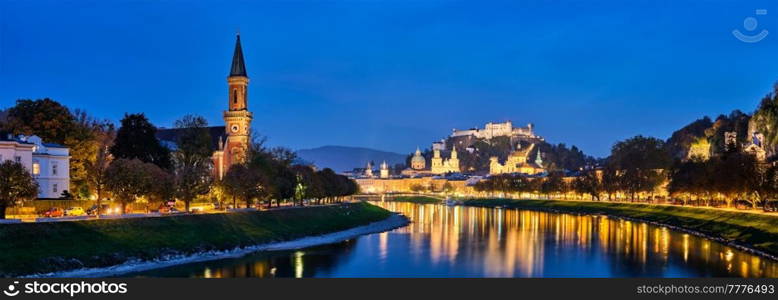 Salzburg city evening panorama. Cathedral, Old Town Altstadt, Evangelische Pfarrgemeinde Salzburg Christuskirche Hohensalzburg castle illuminated at night. Salzach River waterfront. Salzburg, Austria. Salzburg city evening panorama